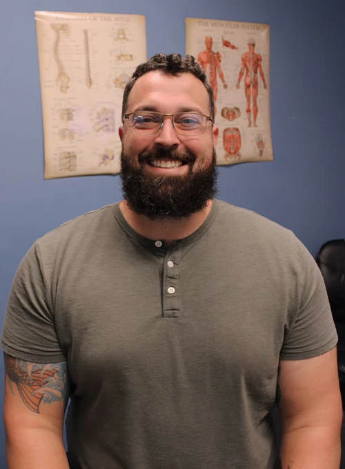 Dr. Jake Harris wearing a short‑sleeve henley shirt